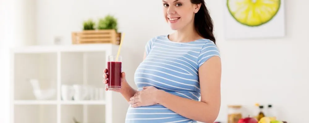Pregnant lady drinking juice detox