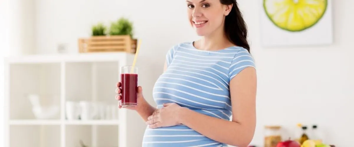 Pregnant lady drinking juice detox