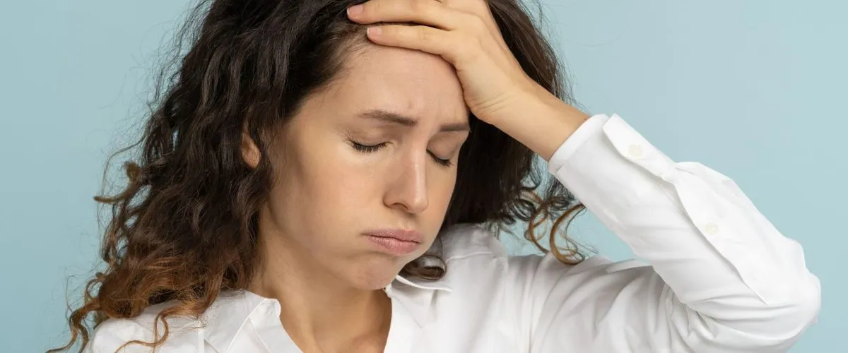 Woman holding her head in pain or to express feeling stressed out and frustrated